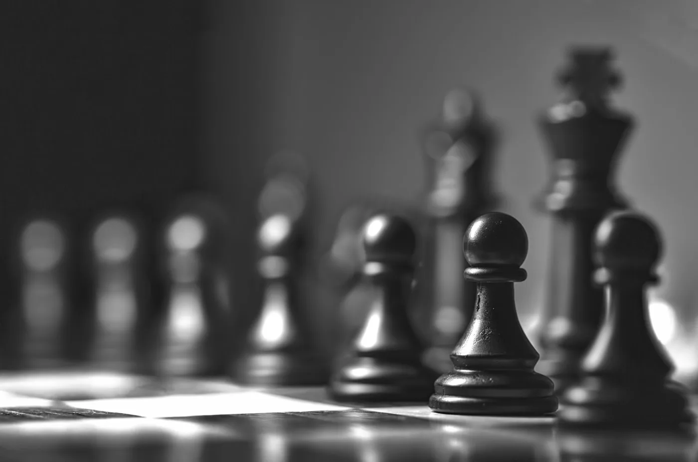 Chess pawns in sharp focus on a board during a strategy lesson at RTI Chess Academy