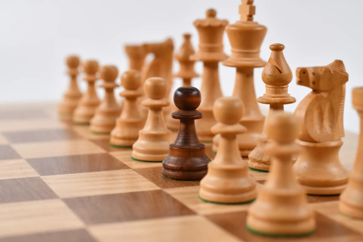 Wooden chess set arranged for a beginner opening lesson